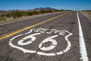 long road with a Route 66 sign painted on it